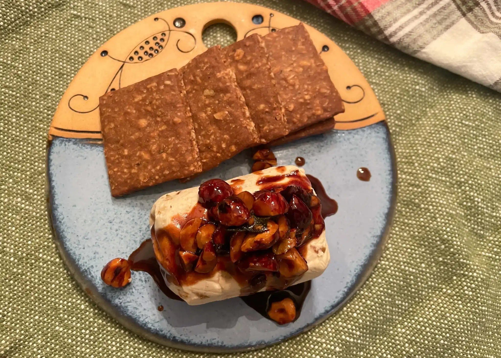 holiday hazelnut honey balsamic glaze drizzled over cheese with crackers