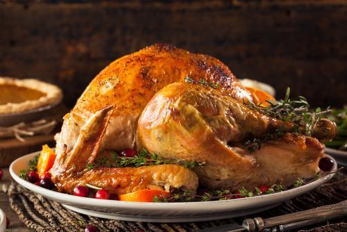 perfectly browned and crisp-skinned turkey plated with veggies and berries