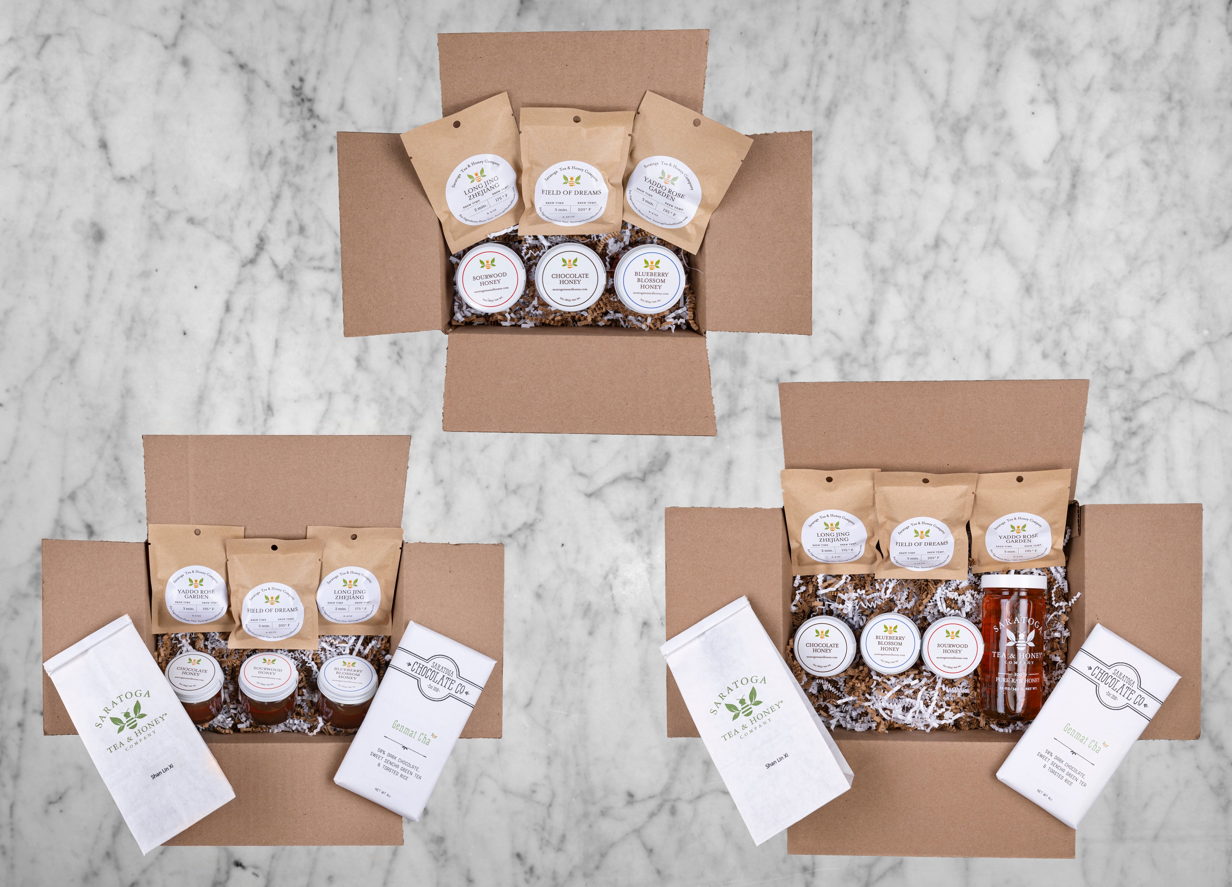 three levels of tea and honey subscription from saratoga tea and honey displayed in shipping boxes