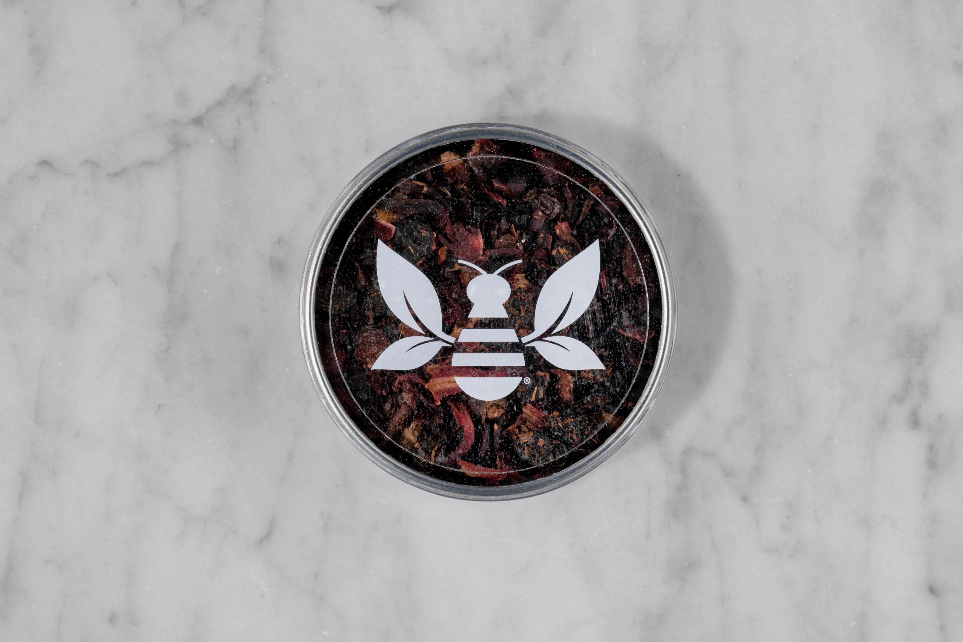 Crimson Berry caffeine-free herbal tisane mini tea tin with a Saratoga Tea & Honey Co. Tea Bee Sticker.