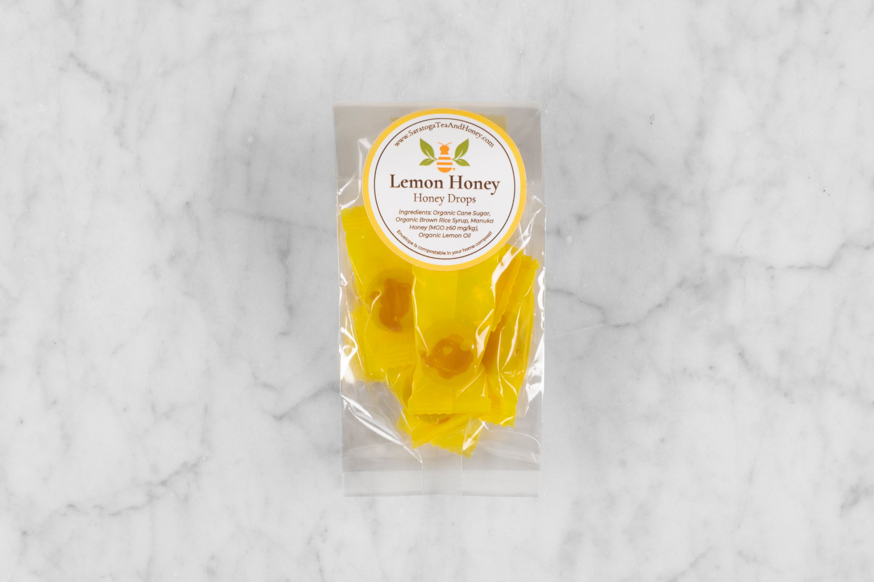 small package of lemon honey candy on marble background