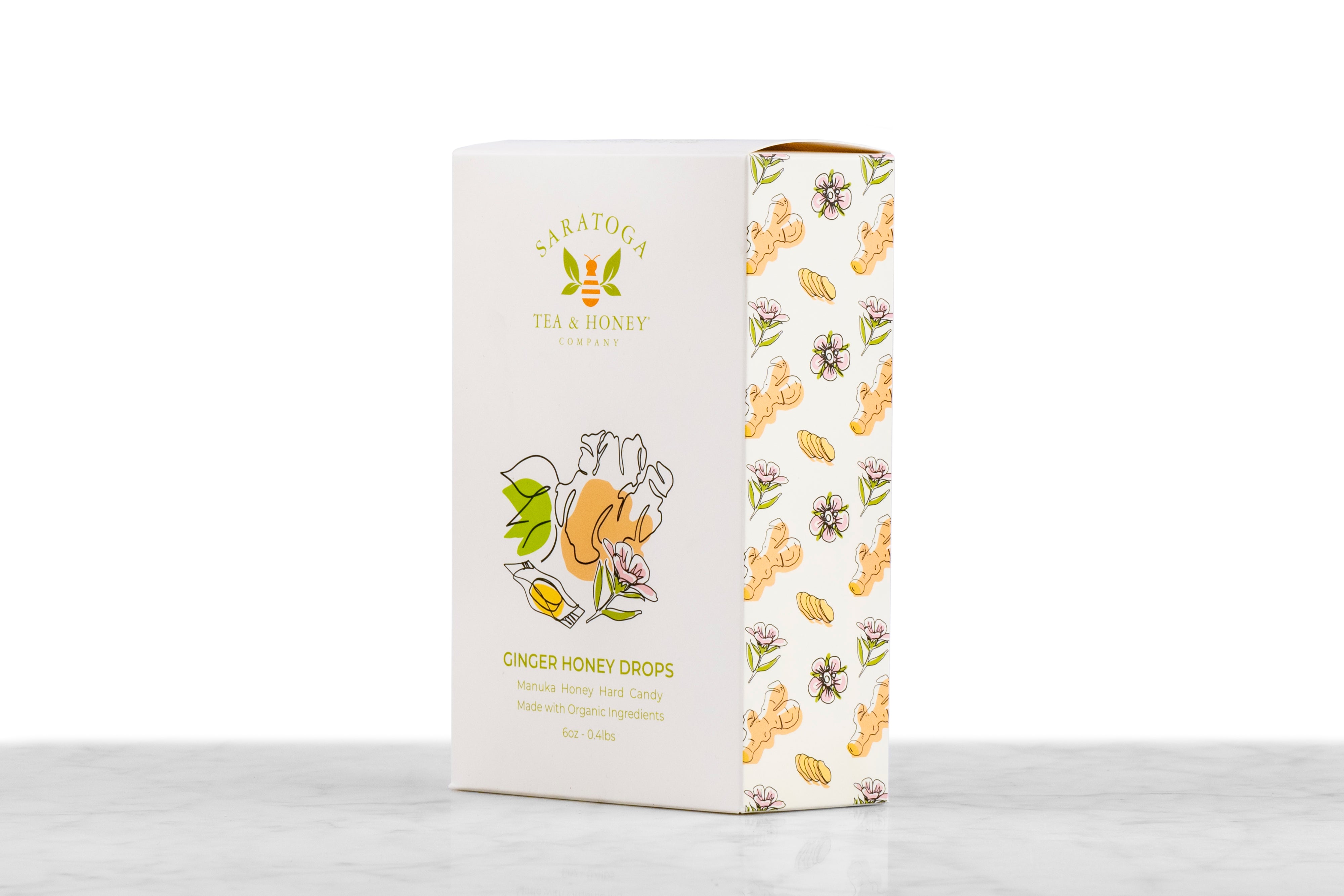 Angled view of Manuka Honey Drops Ginger honey candy box from Saratoga Tea & Honey Co. showing front and side design