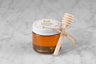 3oz jar of Orange Blossom Honey with twine and mini dipper on a marble background