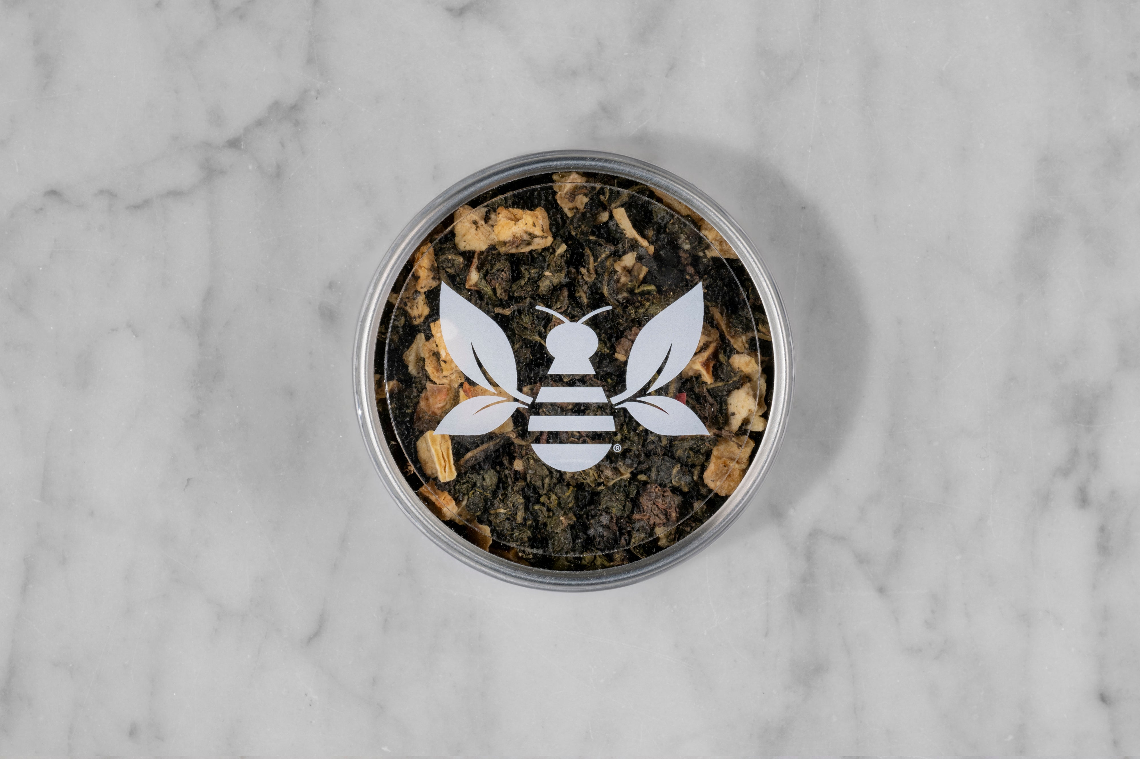 The Apricot Queen scented oolong mini tea tin with a Saratoga Tea & Honey Co. Tea Bee Sticker.