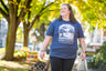 woman walking down the street in blue High Steeps tea pun tshirt from Saratoga Tea & Honey Co.