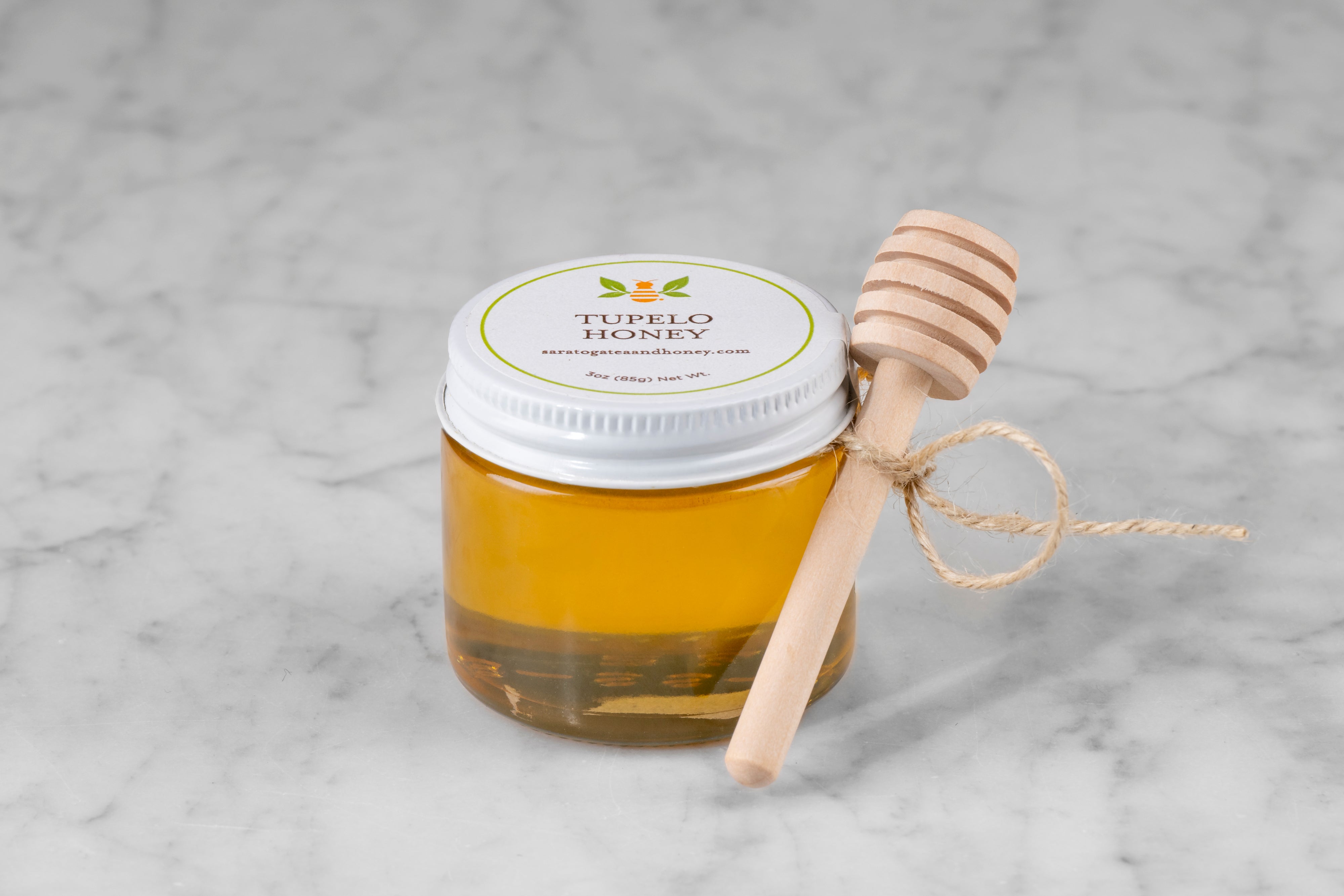 mini 3 oz jar of tupelo honey from Saratoga Tea & Honey co. with twine and mini dipper perfect for stocking stuffers or small gifts