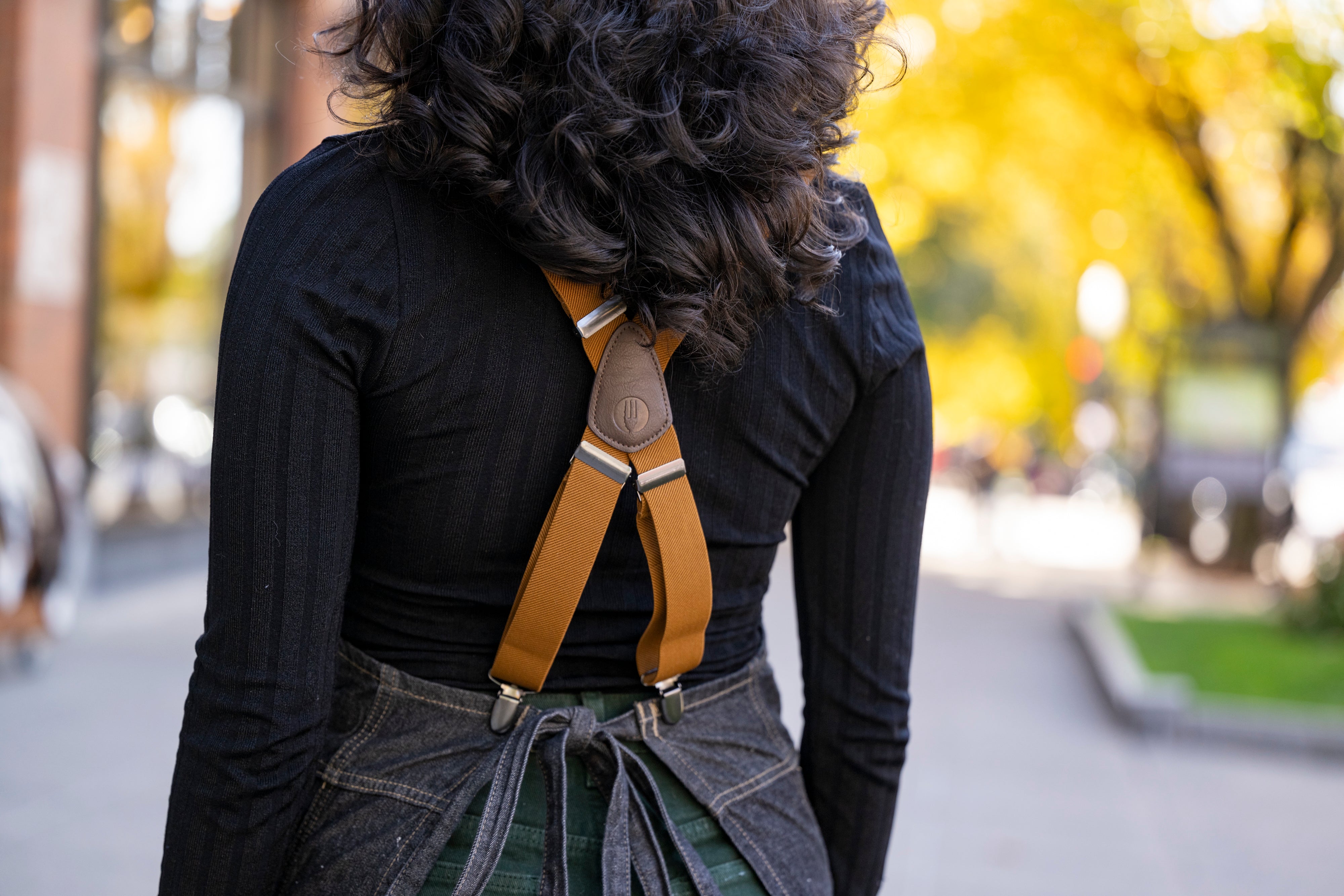 close up of adjustable suspender straps for Saratoga Tea & Honey Co. apron