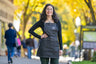 woman with black hair wearing a denim Saratoga Tea & Honey Co. apron on Broadway in Saratoga Springs NY